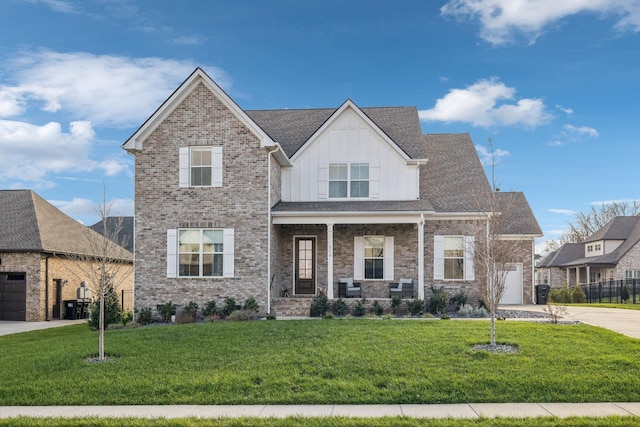 view of front of property featuring a porch, a garage, and a front lawn