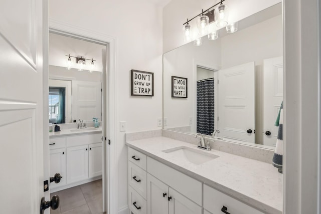 bathroom with tile patterned floors and vanity