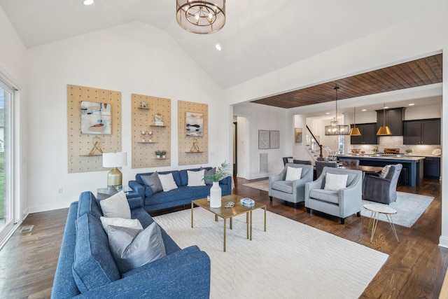 living room with a chandelier, dark hardwood / wood-style floors, and a healthy amount of sunlight