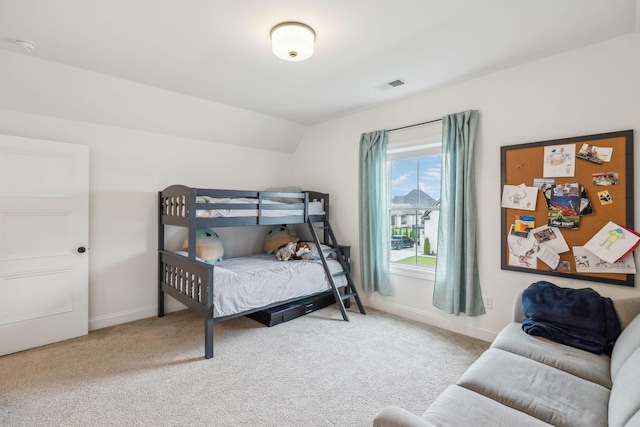 bedroom featuring carpet floors and vaulted ceiling