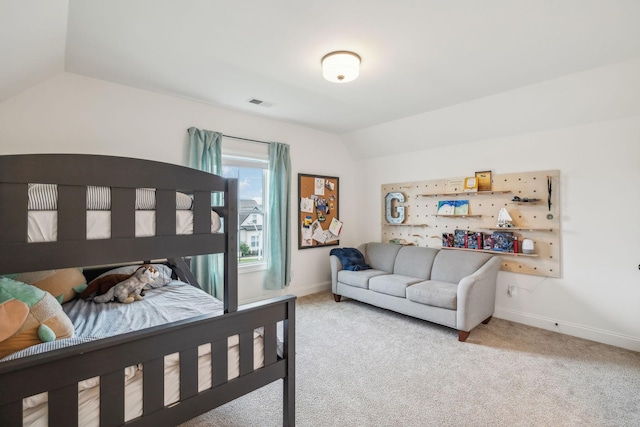 carpeted bedroom with vaulted ceiling