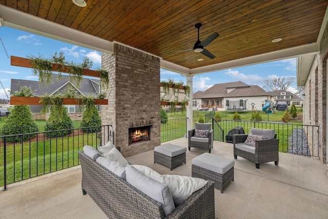 view of patio / terrace featuring an outdoor living space with a fireplace and ceiling fan