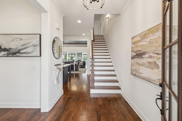 foyer with dark hardwood / wood-style flooring and ornamental molding