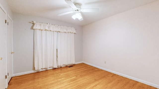 spare room with wood-type flooring and ceiling fan