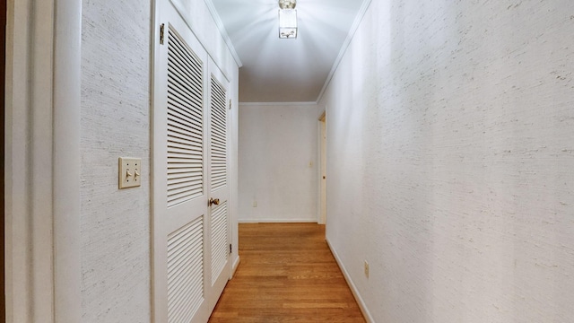 corridor featuring hardwood / wood-style flooring and ornamental molding