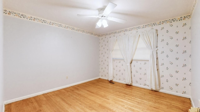 unfurnished room with ceiling fan and hardwood / wood-style flooring