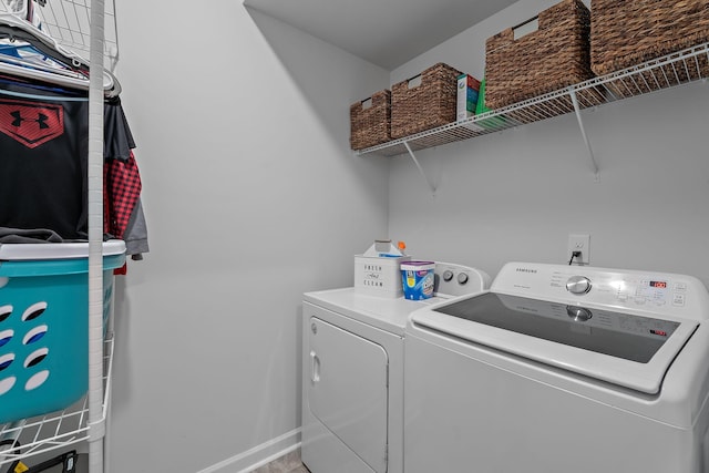 clothes washing area with washing machine and dryer