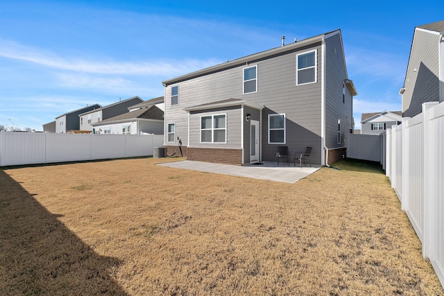 rear view of property featuring a yard, a patio, and central air condition unit