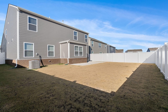 back of house featuring a yard and cooling unit