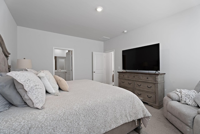 carpeted bedroom with ensuite bath