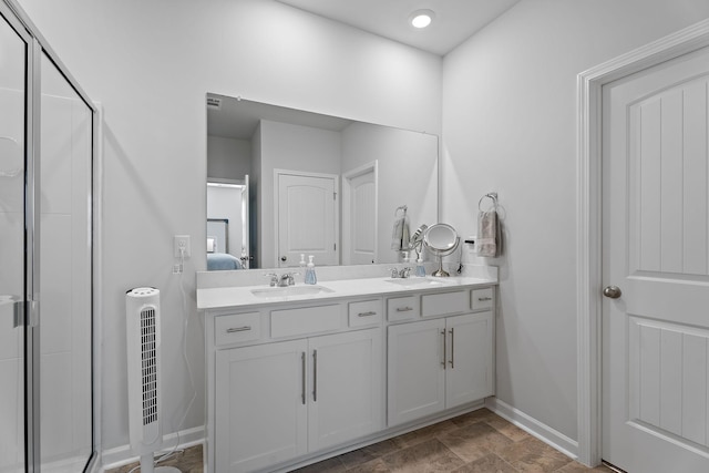 bathroom with vanity and a shower with shower door