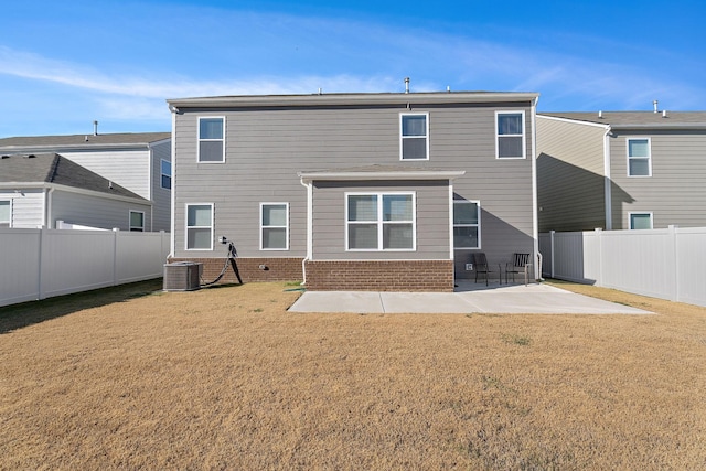 back of property with a patio area, a yard, and cooling unit