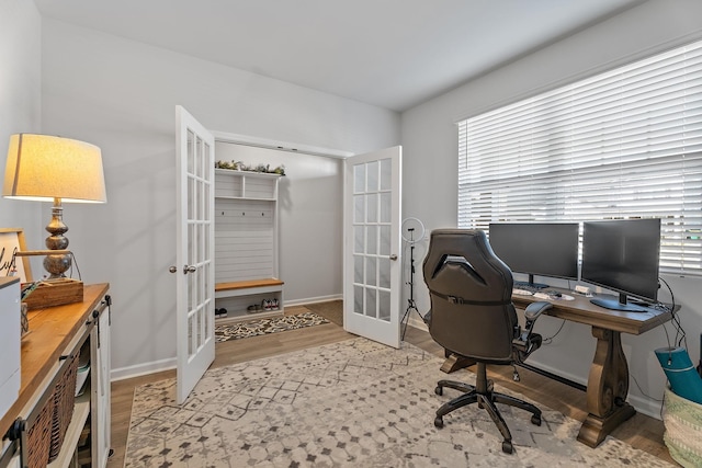 home office featuring light hardwood / wood-style flooring and french doors