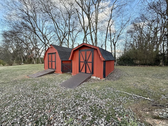 view of outbuilding featuring a lawn