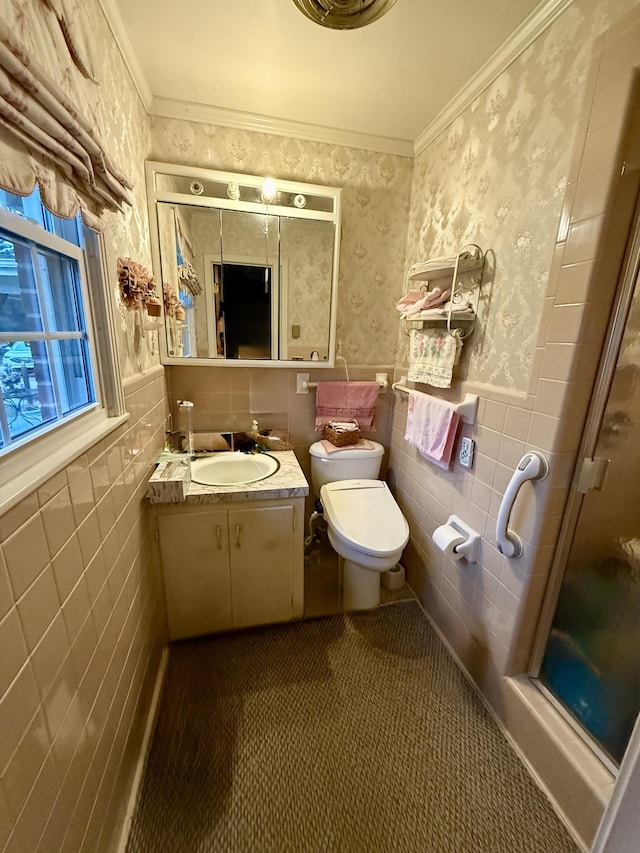 bathroom with crown molding, vanity, tile walls, and toilet