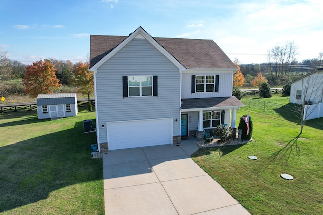 view of front facade featuring cooling unit, a front lawn, a garage, and a storage shed