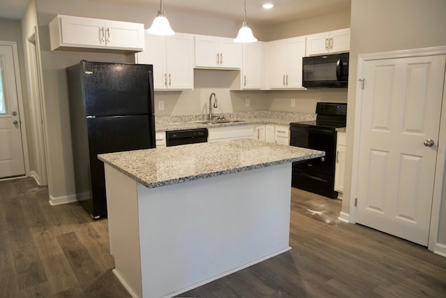 kitchen with sink, black appliances, pendant lighting, white cabinets, and a kitchen island