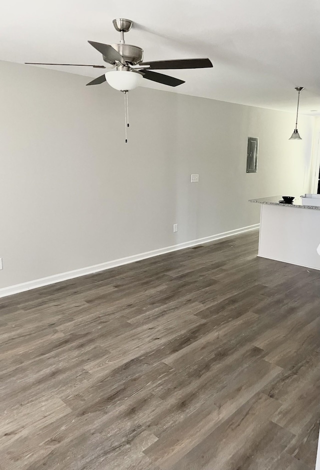 empty room featuring ceiling fan and dark wood-type flooring