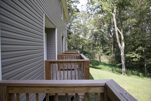 wooden terrace featuring a yard