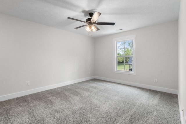 carpeted spare room featuring ceiling fan