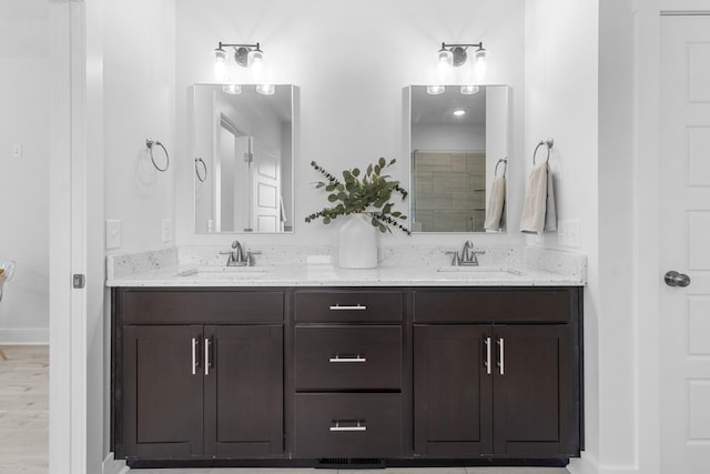 bathroom with hardwood / wood-style floors and vanity