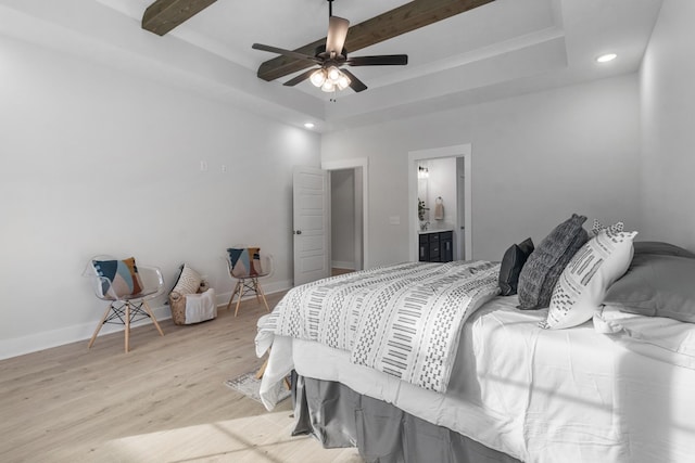 bedroom featuring beamed ceiling, ceiling fan, light hardwood / wood-style floors, and connected bathroom