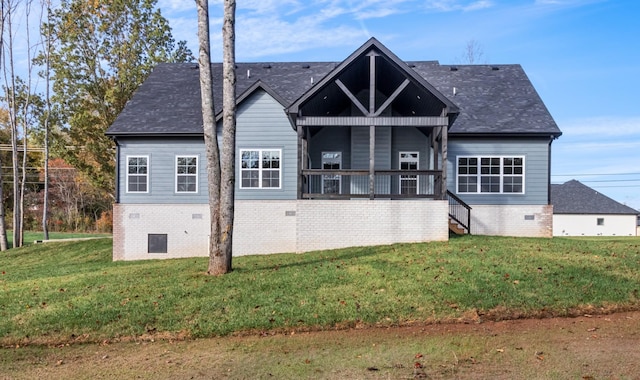 rear view of property with a lawn