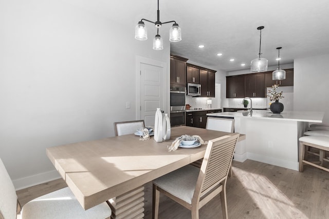 dining space featuring light hardwood / wood-style flooring and sink