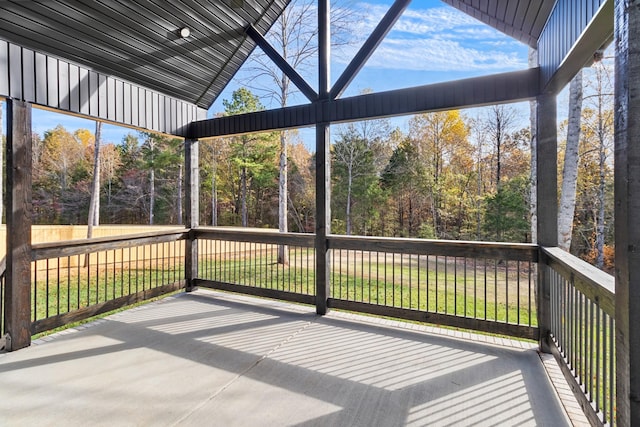 unfurnished sunroom with lofted ceiling