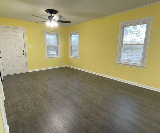 spare room featuring ceiling fan and dark hardwood / wood-style flooring