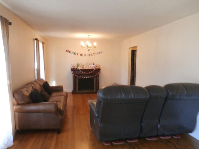 living room with wood-type flooring and a notable chandelier