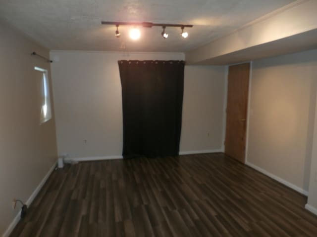 unfurnished room featuring dark hardwood / wood-style flooring