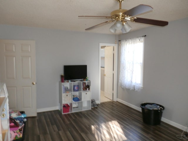 interior space featuring dark hardwood / wood-style flooring and ceiling fan