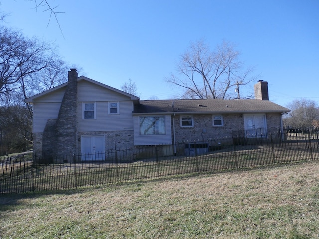 rear view of property with a yard