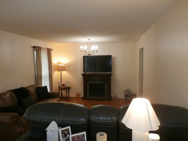 1005 Emily Dr, Goodlettsville, TN 37072 - living room with baseboards, wood finished floors, a fireplace with raised hearth, and an inviting chandelier
