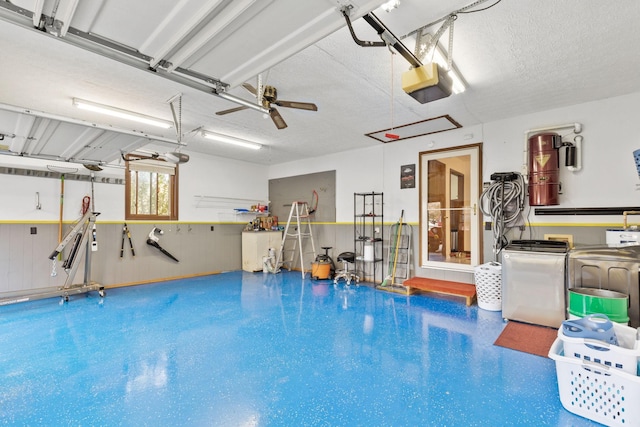 garage featuring washer and dryer, ceiling fan, and a garage door opener