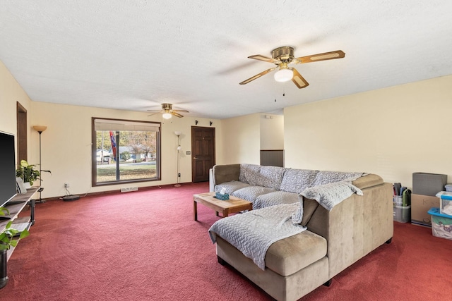 carpeted living room with ceiling fan and a textured ceiling