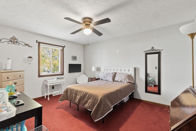 carpeted bedroom with a textured ceiling and ceiling fan