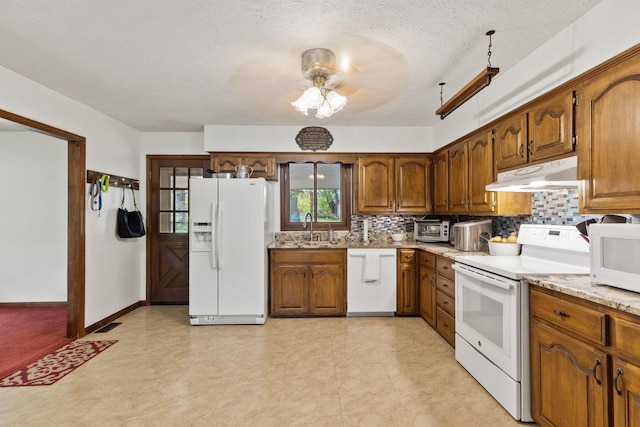 kitchen with ceiling fan, sink, a textured ceiling, white appliances, and decorative backsplash