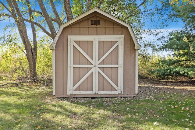 view of outbuilding with a lawn