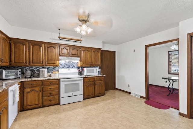 kitchen featuring ceiling fan, white appliances, a textured ceiling, and tasteful backsplash