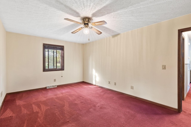 empty room featuring carpet flooring, ceiling fan, and a textured ceiling