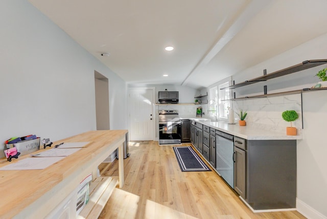 kitchen with tasteful backsplash, light hardwood / wood-style flooring, lofted ceiling, gray cabinets, and appliances with stainless steel finishes