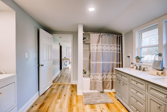 bathroom with shower / bath combination with curtain, vanity, washer / clothes dryer, and hardwood / wood-style floors