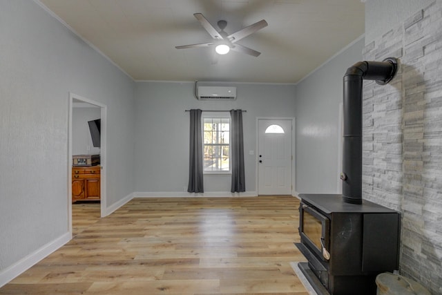 70 Laneview Concord Rd, Trenton, TN 38382 - entrance foyer with an AC wall unit, a wood stove, ornamental molding, a ceiling fan, and light wood finished floors