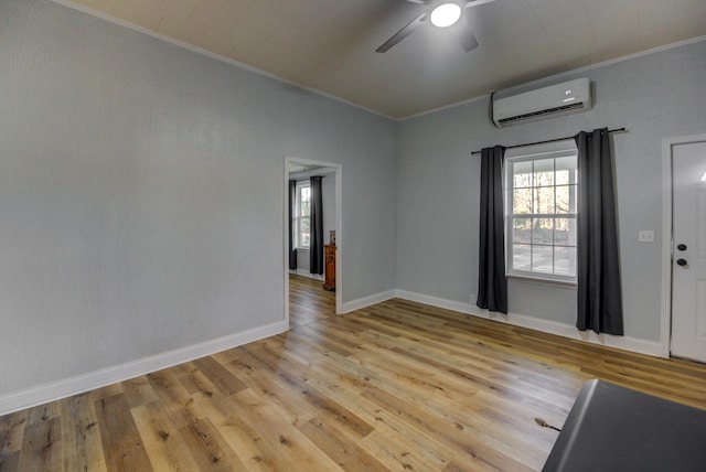 70 Laneview Concord Rd, Trenton, TN 38382 - empty room featuring a wall mounted air conditioner, healthy amount of natural light, a ceiling fan, ornamental molding, and light wood-style floors