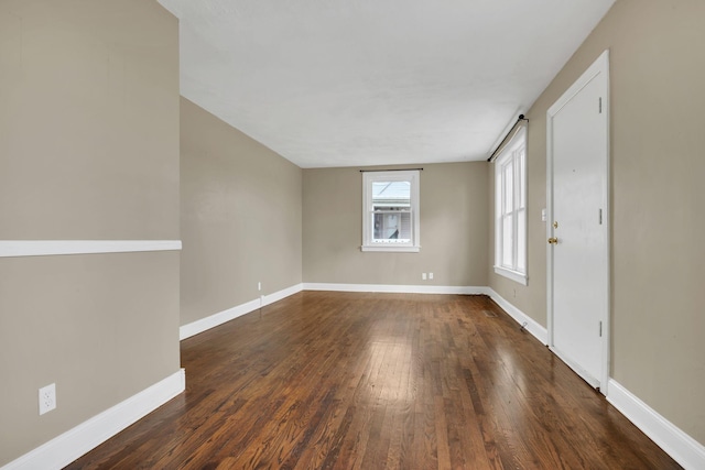 unfurnished room featuring dark hardwood / wood-style flooring