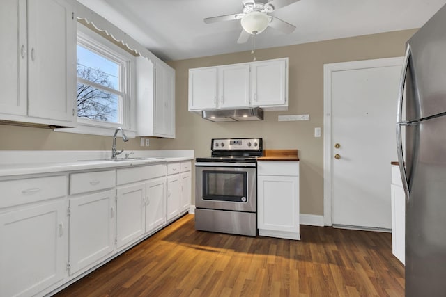 kitchen featuring white cabinets, appliances with stainless steel finishes, sink, and range hood