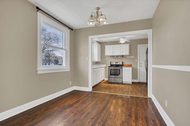 kitchen featuring appliances with stainless steel finishes, white cabinetry, dark wood-type flooring, and sink