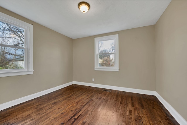 empty room with dark hardwood / wood-style floors